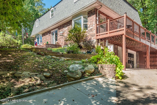 view of side of property with a wooden deck