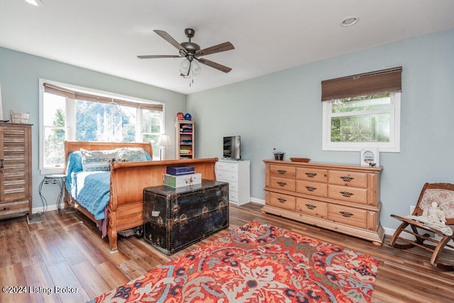 bedroom with ceiling fan and hardwood / wood-style flooring