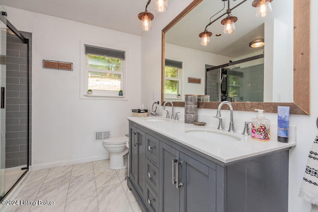 bathroom with vanity, toilet, and a shower with shower door