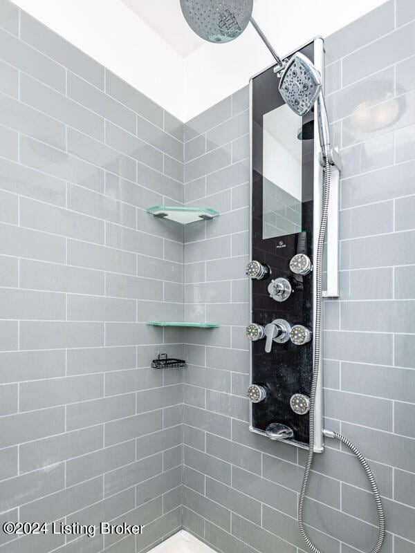 bathroom with tiled shower