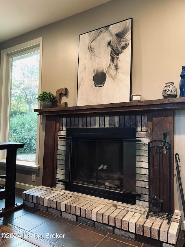 interior details featuring a brick fireplace