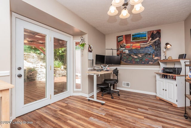 office space featuring a chandelier, hardwood / wood-style floors, and a textured ceiling