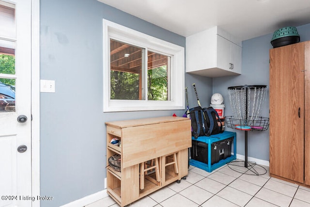 interior space with white cabinets and light tile patterned flooring