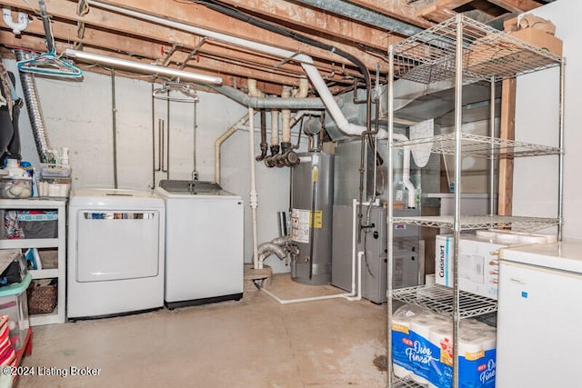 basement featuring washer and clothes dryer and water heater