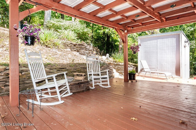 wooden deck with a storage shed