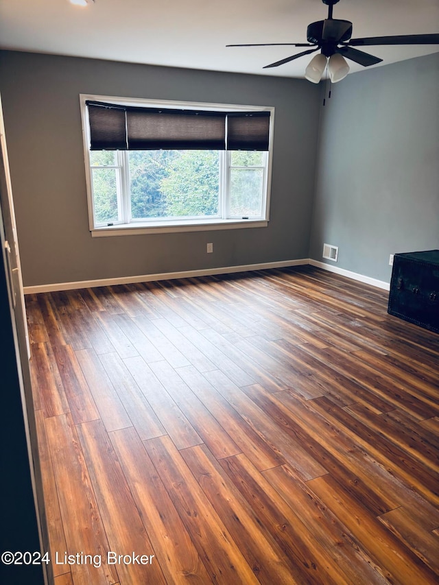 spare room featuring ceiling fan and dark hardwood / wood-style flooring