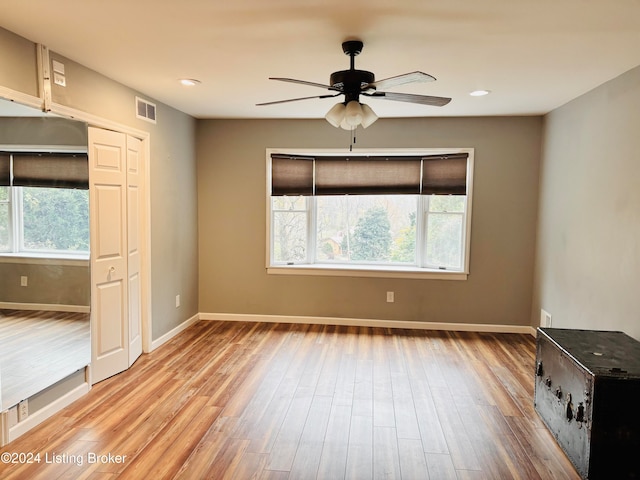 interior space featuring hardwood / wood-style floors, ceiling fan, and a healthy amount of sunlight