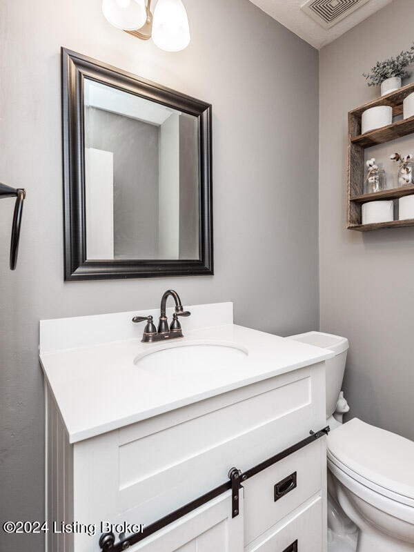 bathroom featuring vanity and toilet