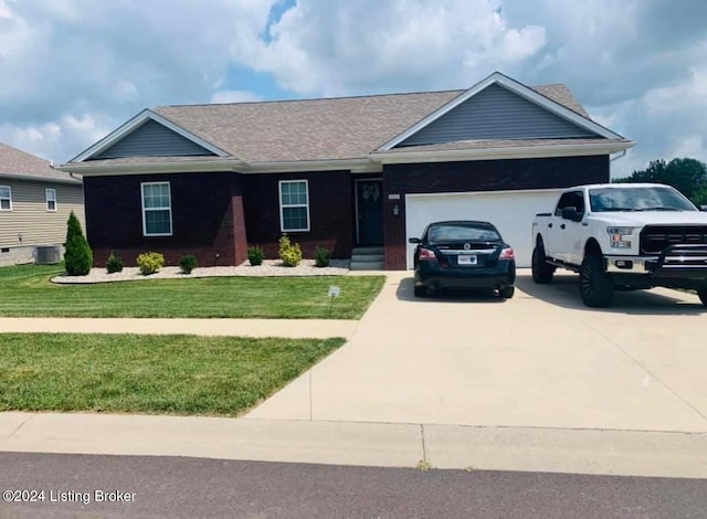 ranch-style home featuring a garage, central air condition unit, and a front yard