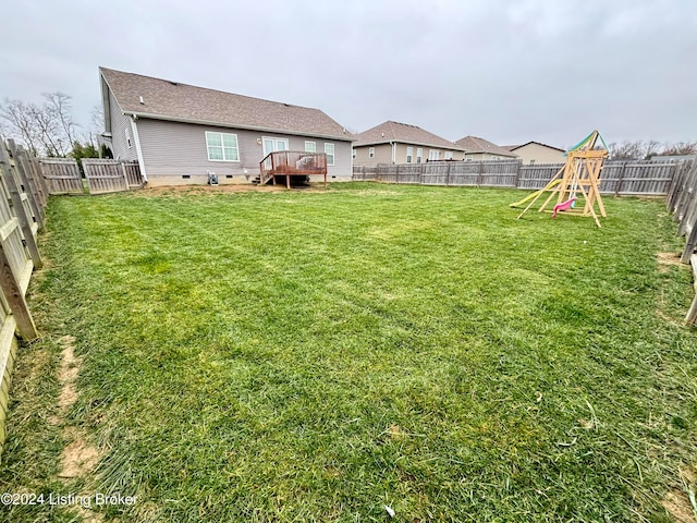 view of yard featuring a playground and a deck