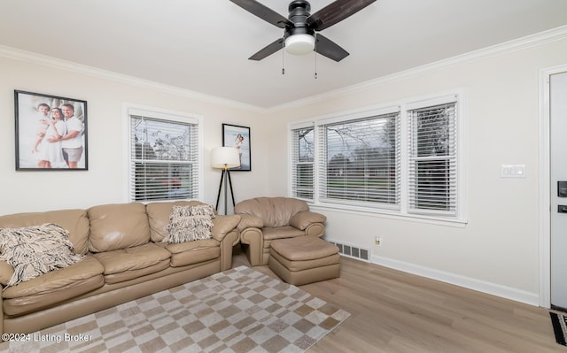 living room featuring ceiling fan, light hardwood / wood-style floors, and crown molding