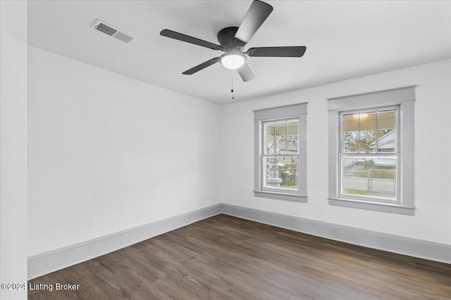 unfurnished room with dark hardwood / wood-style flooring and ceiling fan