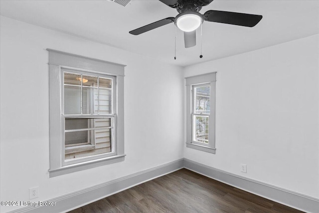 unfurnished room with dark hardwood / wood-style flooring and ceiling fan