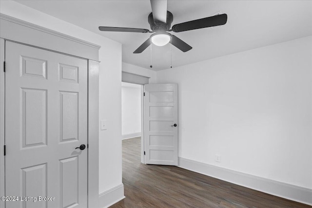 spare room featuring ceiling fan and dark wood-type flooring