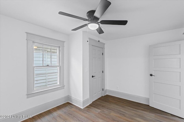 unfurnished bedroom with hardwood / wood-style floors, ceiling fan, and a closet