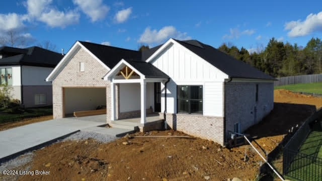 modern farmhouse style home featuring a garage