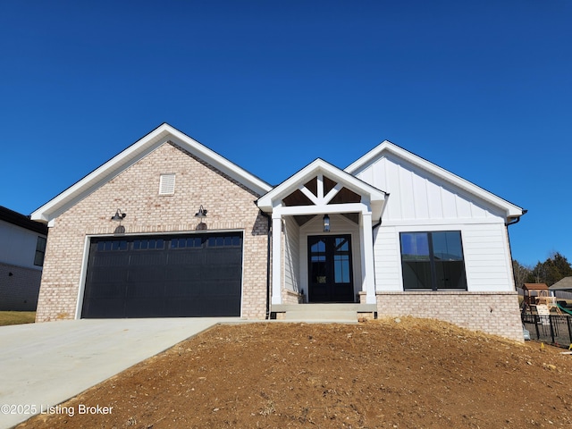 modern farmhouse with board and batten siding, concrete driveway, brick siding, and a garage