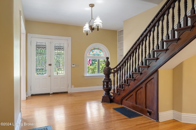 foyer featuring a chandelier and light hardwood / wood-style flooring