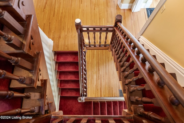 staircase featuring wood walls