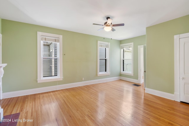 spare room with ceiling fan and light wood-type flooring