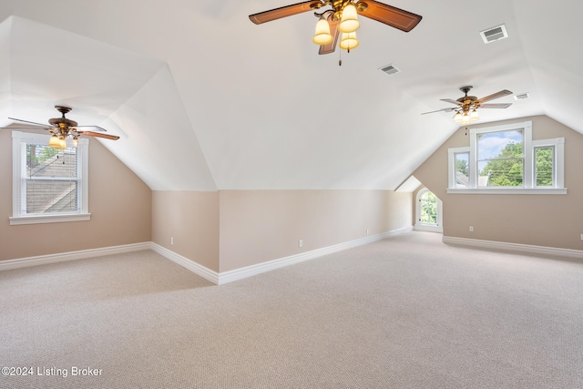 additional living space featuring ceiling fan, light carpet, and vaulted ceiling