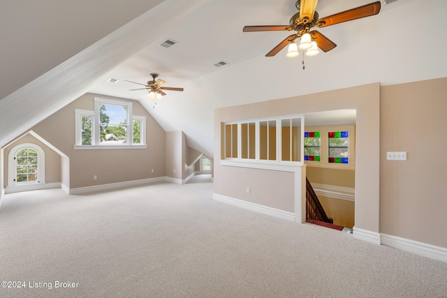 bonus room featuring ceiling fan, light carpet, and vaulted ceiling