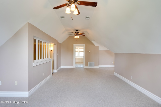 additional living space featuring light carpet, ceiling fan, and lofted ceiling