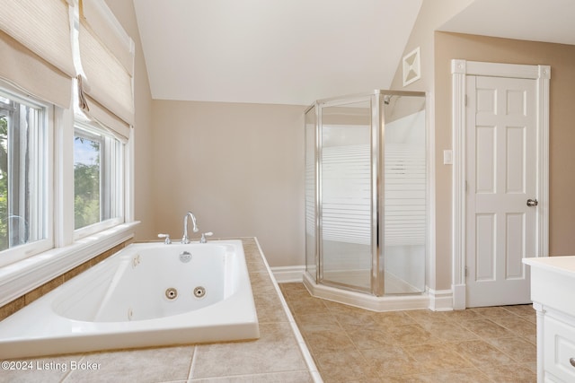 bathroom with plus walk in shower, tile patterned flooring, vanity, and lofted ceiling