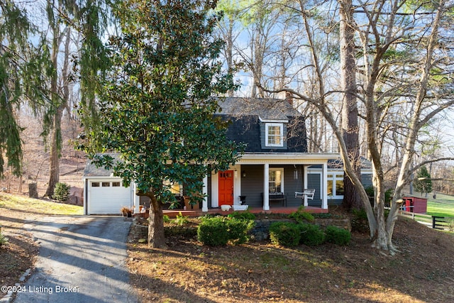 view of front of property with covered porch and a garage