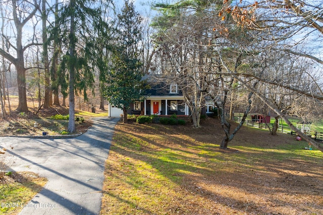 view of front of home with a front yard and a porch