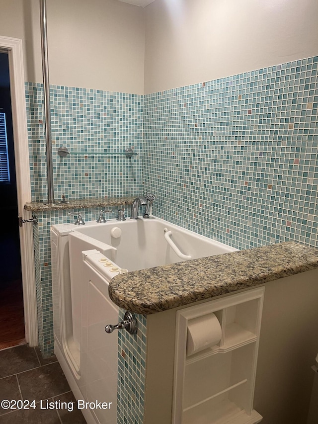 bathroom featuring tile patterned flooring, tile walls, and a bathing tub