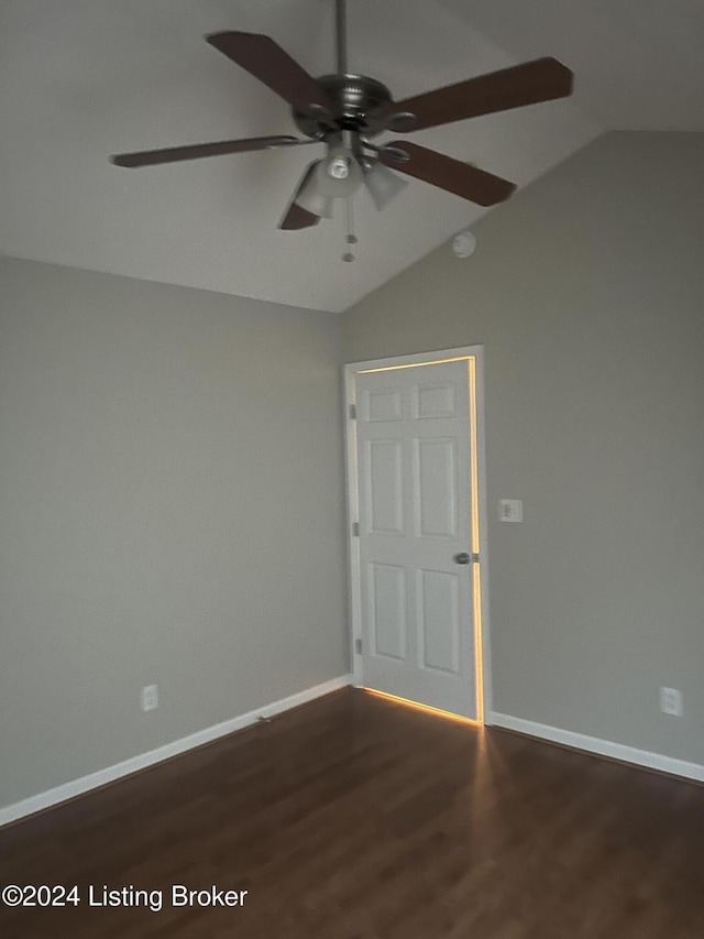 spare room featuring ceiling fan, lofted ceiling, and dark wood-type flooring