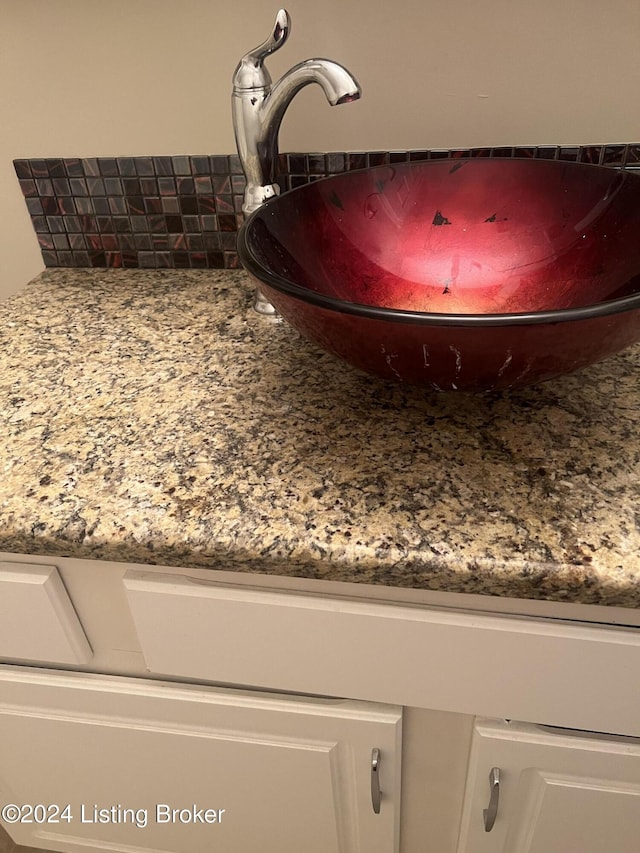 interior details featuring backsplash and sink