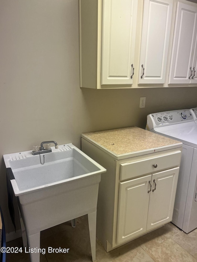 laundry room featuring washer and dryer, sink, light tile patterned floors, and cabinets