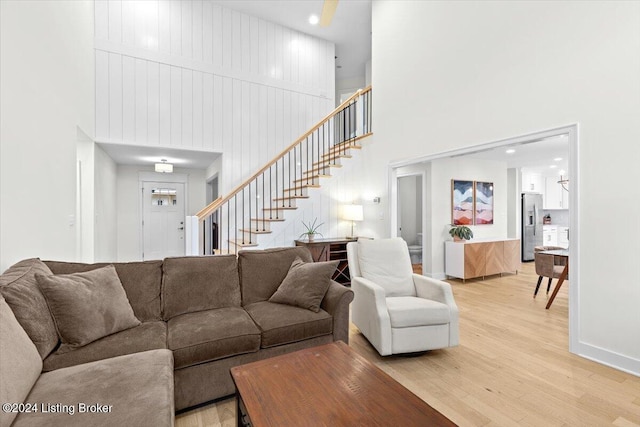 living room with a high ceiling and hardwood / wood-style flooring