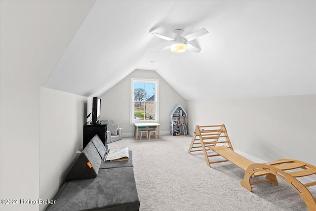 living area featuring carpet floors, ceiling fan, and lofted ceiling