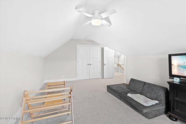 interior space with ceiling fan, carpet floors, and lofted ceiling