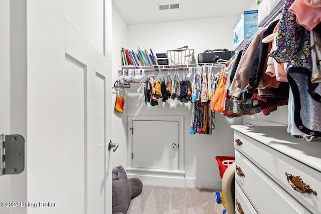 walk in closet with carpet