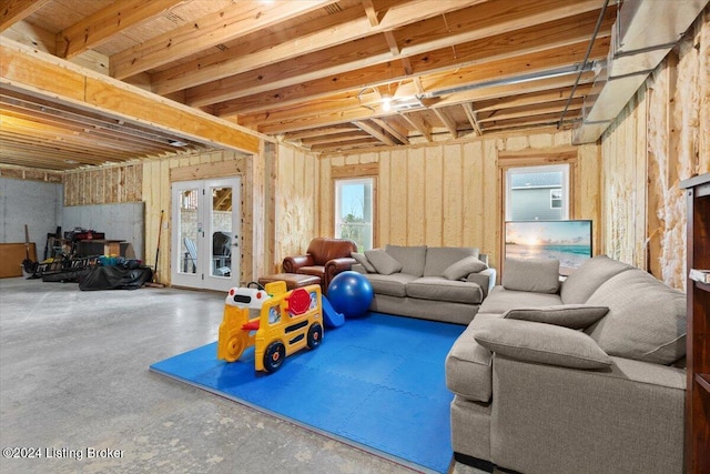 living room with french doors and concrete floors