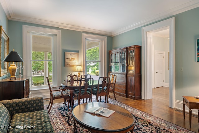 dining room featuring hardwood / wood-style floors and crown molding