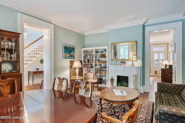 sitting room featuring wood-type flooring and crown molding