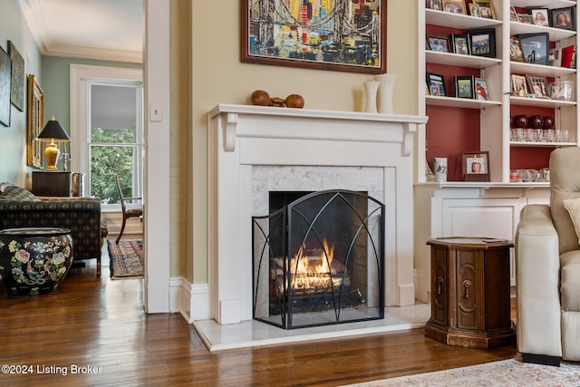 sitting room featuring crown molding, dark hardwood / wood-style flooring, and a fireplace