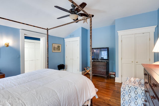 bedroom with multiple closets, ceiling fan, and dark wood-type flooring