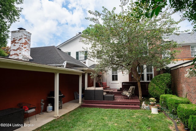 rear view of house with outdoor lounge area, a yard, and a wooden deck