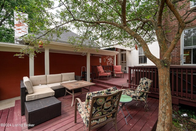 wooden deck with an outdoor living space