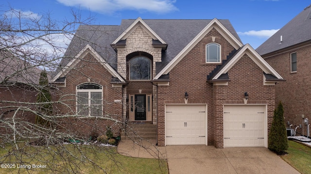 view of front facade featuring a garage, concrete driveway, brick siding, and stone siding