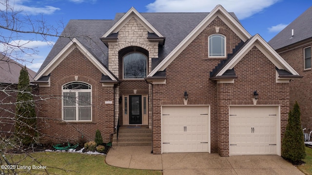 view of front facade with brick siding, a shingled roof, an attached garage, stone siding, and driveway