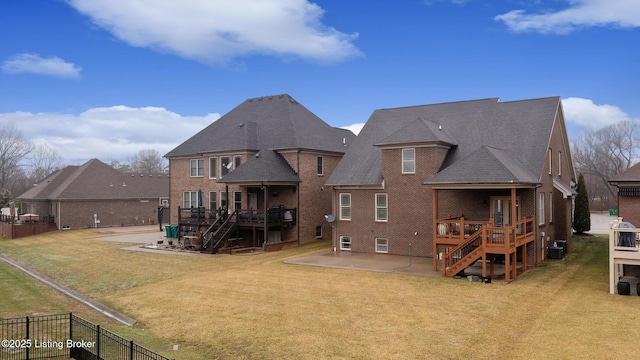 rear view of property with a patio area, brick siding, and stairway