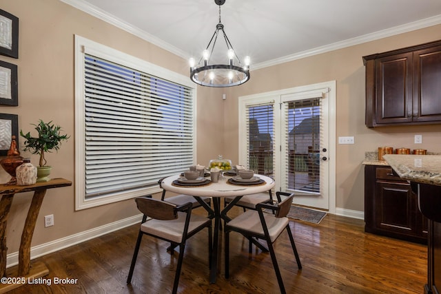 dining area featuring dark wood-style floors, baseboards, crown molding, and an inviting chandelier