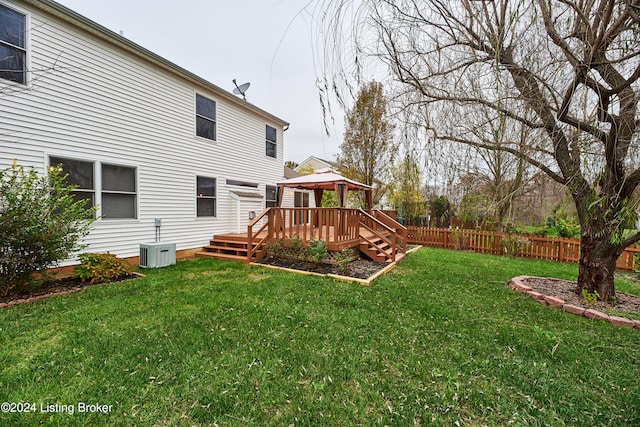 view of yard with a gazebo, central AC unit, and a wooden deck